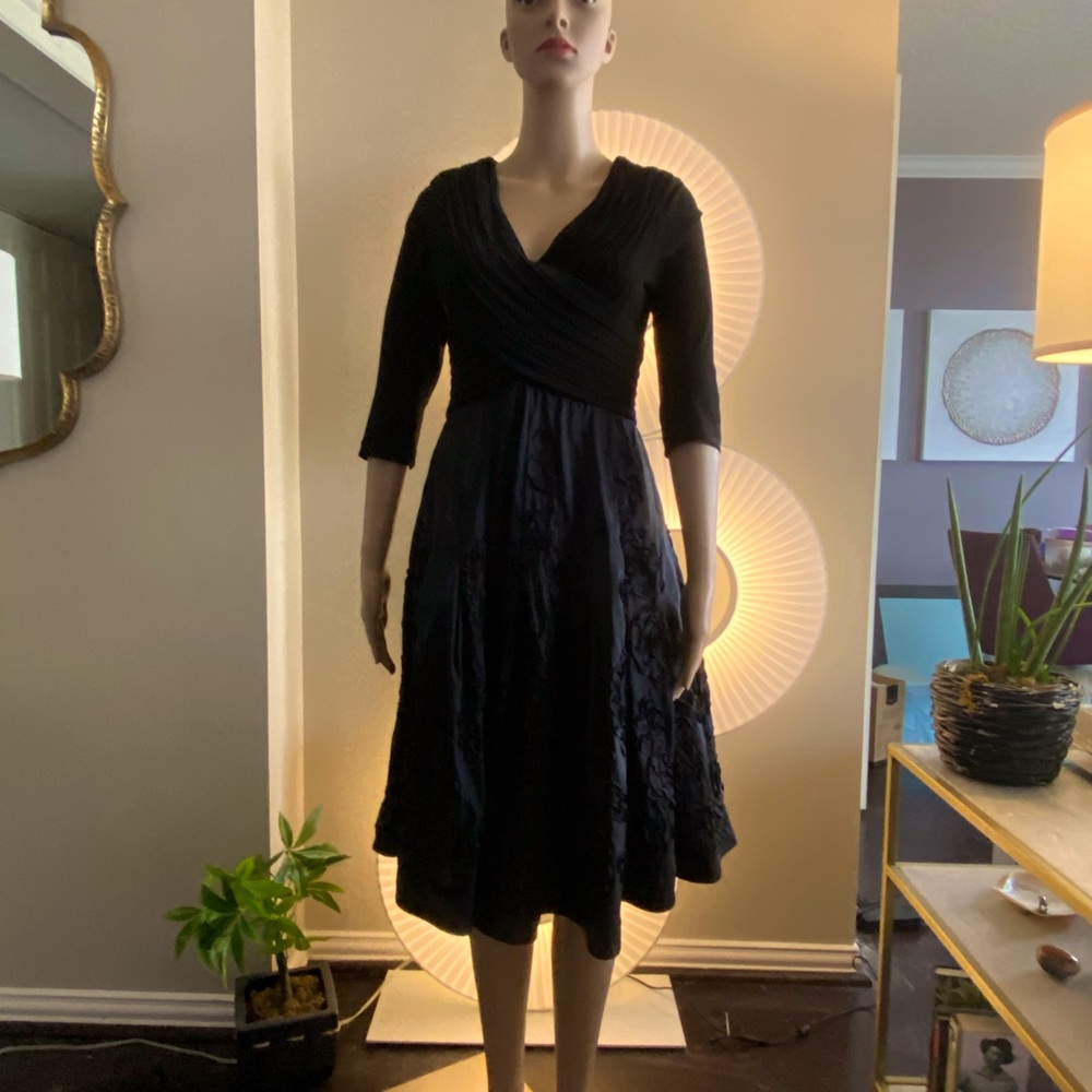 Beautiful & fun party dress.  The skirt has a flowery flow to it. Worn once.